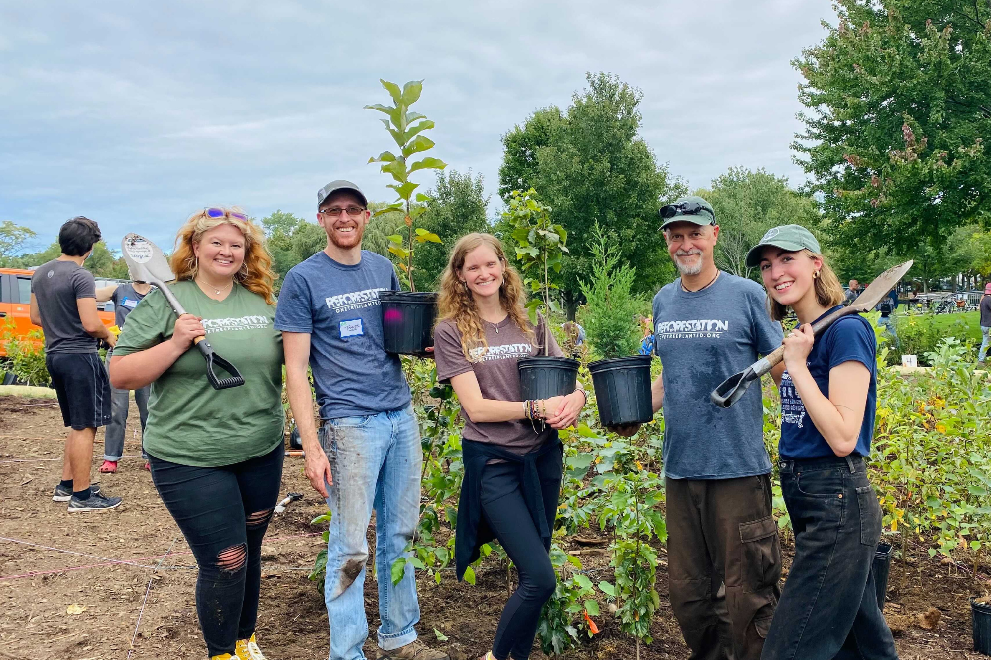 One Tree Planted team gathers around planting site